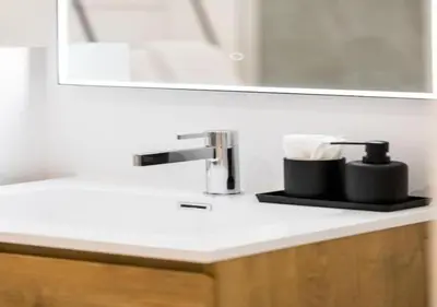 a bathroom counter with a sink and a mirror at Charming house in city center in Antwerp