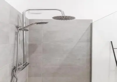 a bathroom with a shower with a shower head at Charming house in city center in Antwerp
