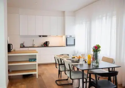 a kitchen with a table and chairs in a room at Magic in the Heart of Antwerp! in Antwerp
