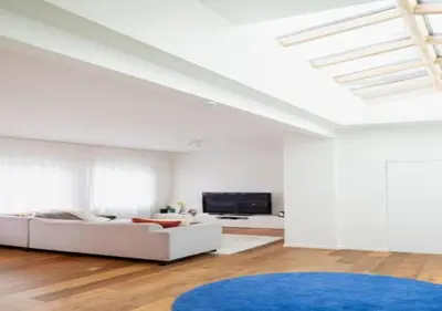 a white living room with a white couch and a blue rug at Magic in the Heart of Antwerp! in Antwerp