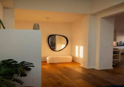 a living room with a mirror and a white couch at Magic in the Heart of Antwerp! in Antwerp