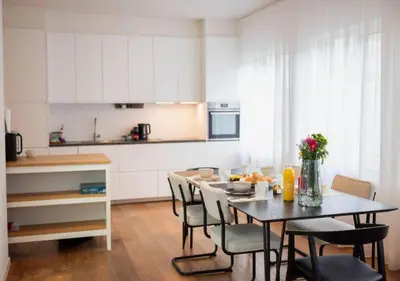 a kitchen with a table and chairs in a kitchen at Magic in the Heart of Antwerp! in Antwerp