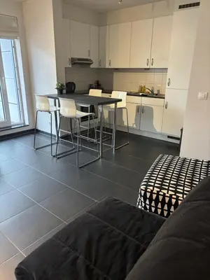 a kitchen with a table and chairs in a room at Beautiful apartment in City Center in Brussels