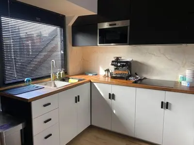 a kitchen with white cabinets and a sink and a window at Apartment Antwerp City center #003 in Antwerp