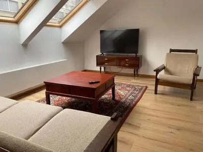 a living room with a couch and a flat screen tv at Apartment Antwerp City center #003 in Antwerp