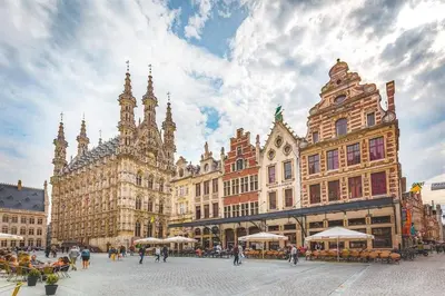a city square with buildings and people walking around at Art Studio Leuven in Leuven