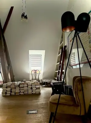 a living room with a couch and a chair and stairs at Art Studio Leuven in Leuven