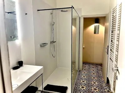 a white bathroom with a shower and a sink at Art Studio Leuven in Leuven