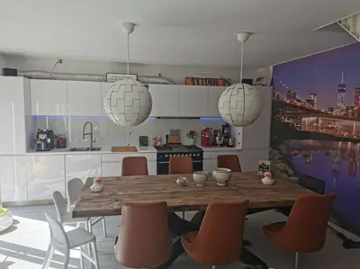 a rendering of a kitchen with a table and chairs at Rustige ruime duplex in Wijnegem