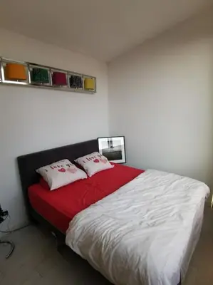 a bedroom with a bed with two pillows on it at Rustige ruime duplex in Wijnegem