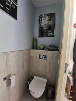 a bathroom with a white toilet in a room at Rustige ruime duplex in Wijnegem