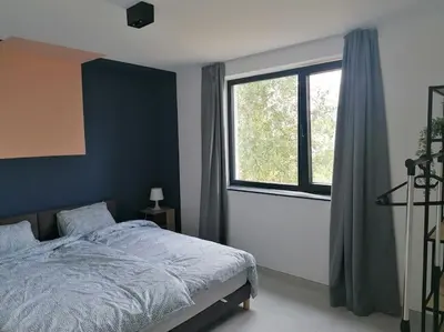 a bedroom with a bed and a large window at Dunehill in Balen