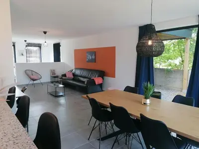 a living room with a table and chairs and a couch at Dunehill in Balen