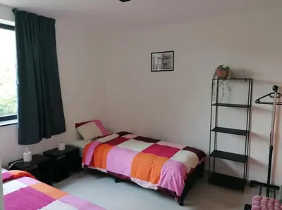 a bedroom with a bed and a book shelf at Dunehill in Balen