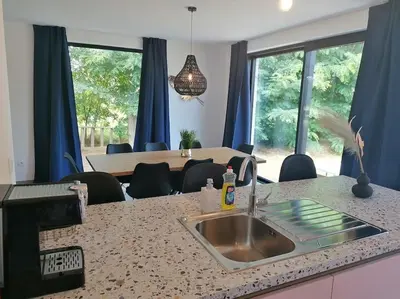 a kitchen with a sink and a living room at Dunehill in Balen