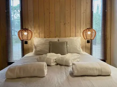 a white bed with two lights on top of it at AWolf in a healthy NEW home in Herentals