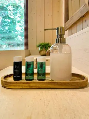 a wooden tray with a bottle of soap and three candles at AWolf in a healthy NEW home in Herentals