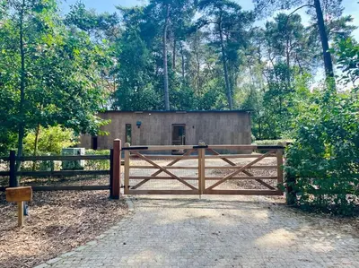 a gate in front of a small building at AWolf in a healthy NEW home in Herentals
