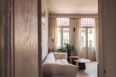 a living room with a couch and a table at Zurenborg Suites in Antwerp