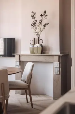 a dining room table with a vase on top of it at Zurenborg Suites in Antwerp