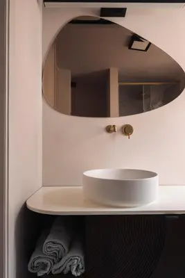 a bathroom with a white sink and a mirror at Zurenborg Suites in Antwerp