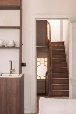 a staircase in a living room with a sink at Zurenborg Suites in Antwerp
