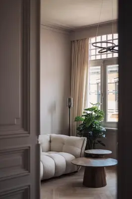 a living room with a couch and a table at Zurenborg Suites in Antwerp