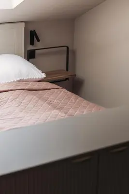 a bedroom with a white bed with a head board at Zurenborg Suites in Antwerp