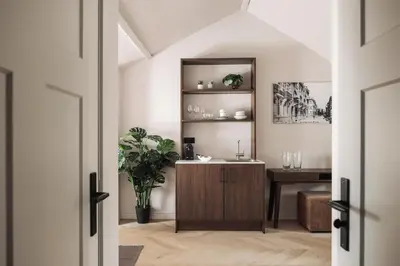 a hallway with a wooden cabinet and a table at Zurenborg Suites in Antwerp