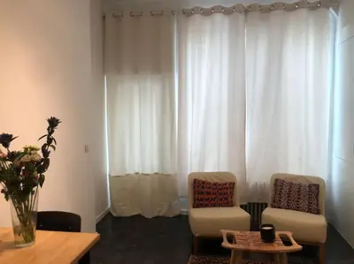 a living room with two chairs and a table at Studio Richard in Antwerp
