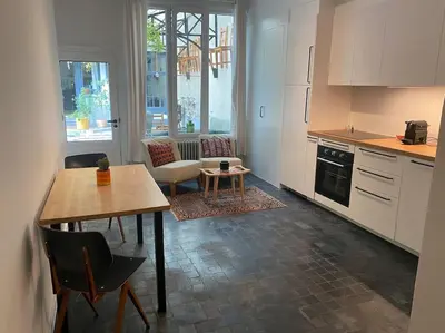 a kitchen with a table and a dining room at Studio Richard in Antwerp