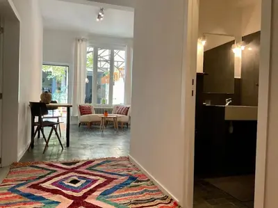 a hallway with a living room and a dining room at Studio Richard in Antwerp