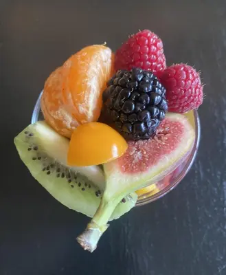 a glass bowl filled with fruit on a table at The Museum - Au Lit, Jérôme! in Antwerp
