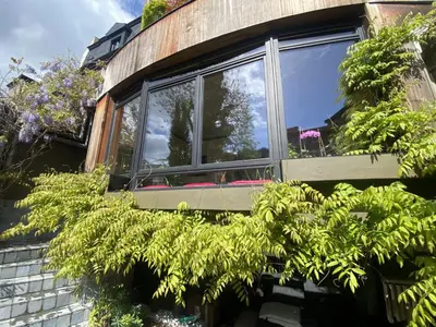 a window on the side of a house with plants at The Museum - Au Lit, Jérôme! in Antwerp