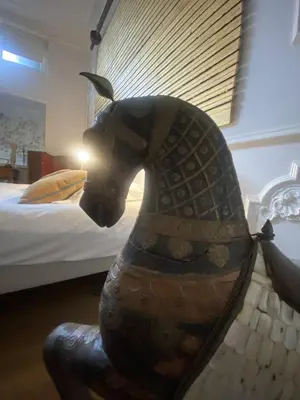 a statue of a horse in front of a bed at The Museum - Au Lit, Jérôme! in Antwerp
