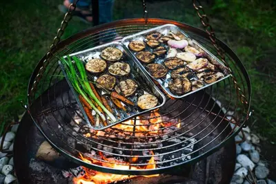 a grill with a tray of food and vegetables on it at ZenCabin - Luxe en Wellness in de natuur in Hulshout