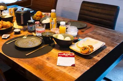 a wooden table with food and drinks on it at ZenCabin - Luxe en Wellness in de natuur in Hulshout
