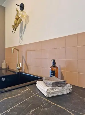 a kitchen counter with a sink and a towel at Fully equiped 100 m2 appt with the perfect location in Vilvoorde