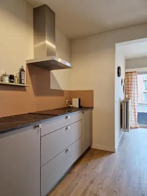 a kitchen with white cabinets and a stove top oven at Fully equiped 100 m2 appt with the perfect location in Vilvoorde