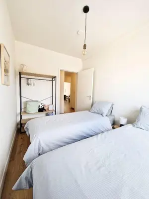 a bedroom with two beds and a mirror at Fully equiped 100 m2 appt with the perfect location in Vilvoorde