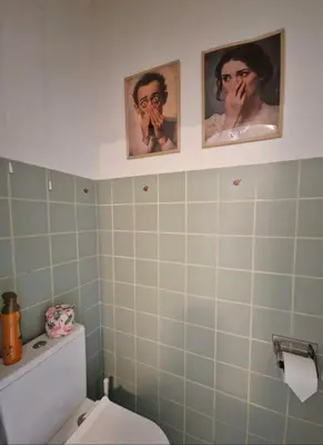 a bathroom with three pictures on the wall above a toilet at Fully equiped 100 m2 appt with the perfect location in Vilvoorde
