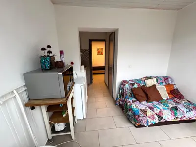 a living room with a couch and a table at Studio situé à Woluwe-Saint-lambert in Brussels