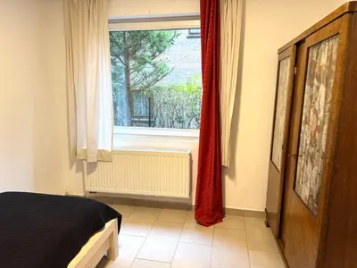 a bedroom with a bed and a window at Studio situé à Woluwe-Saint-lambert in Brussels