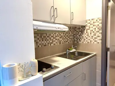 a kitchen with a sink and a counter top at Studio situé à Woluwe-Saint-lambert in Brussels
