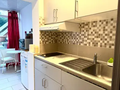 a kitchen with a sink and a counter top at Studio situé à Woluwe-Saint-lambert in Brussels