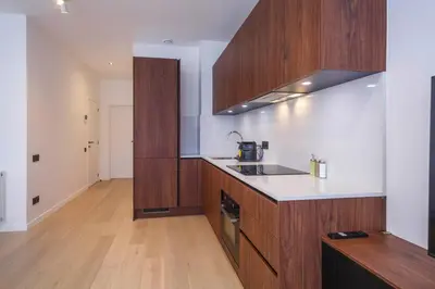 a kitchen with wooden cabinets and a counter top at Märch - Mechelen Goat 14 in Mechelen