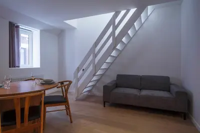 a living room with a couch and a table at Märch - Mechelen Goat 14 in Mechelen