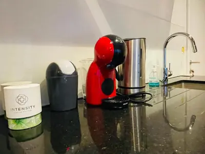 a red coffee maker sitting on a kitchen counter at Studio Intensity in Antwerp
