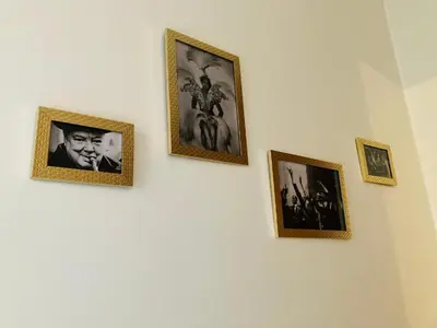 a group of framed pictures on a wall at Living History - Suikernest in Antwerp