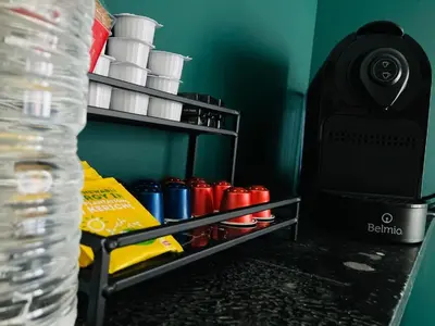 a shelf with cups on it next to a water bottle at Living History - Suikernest in Antwerp